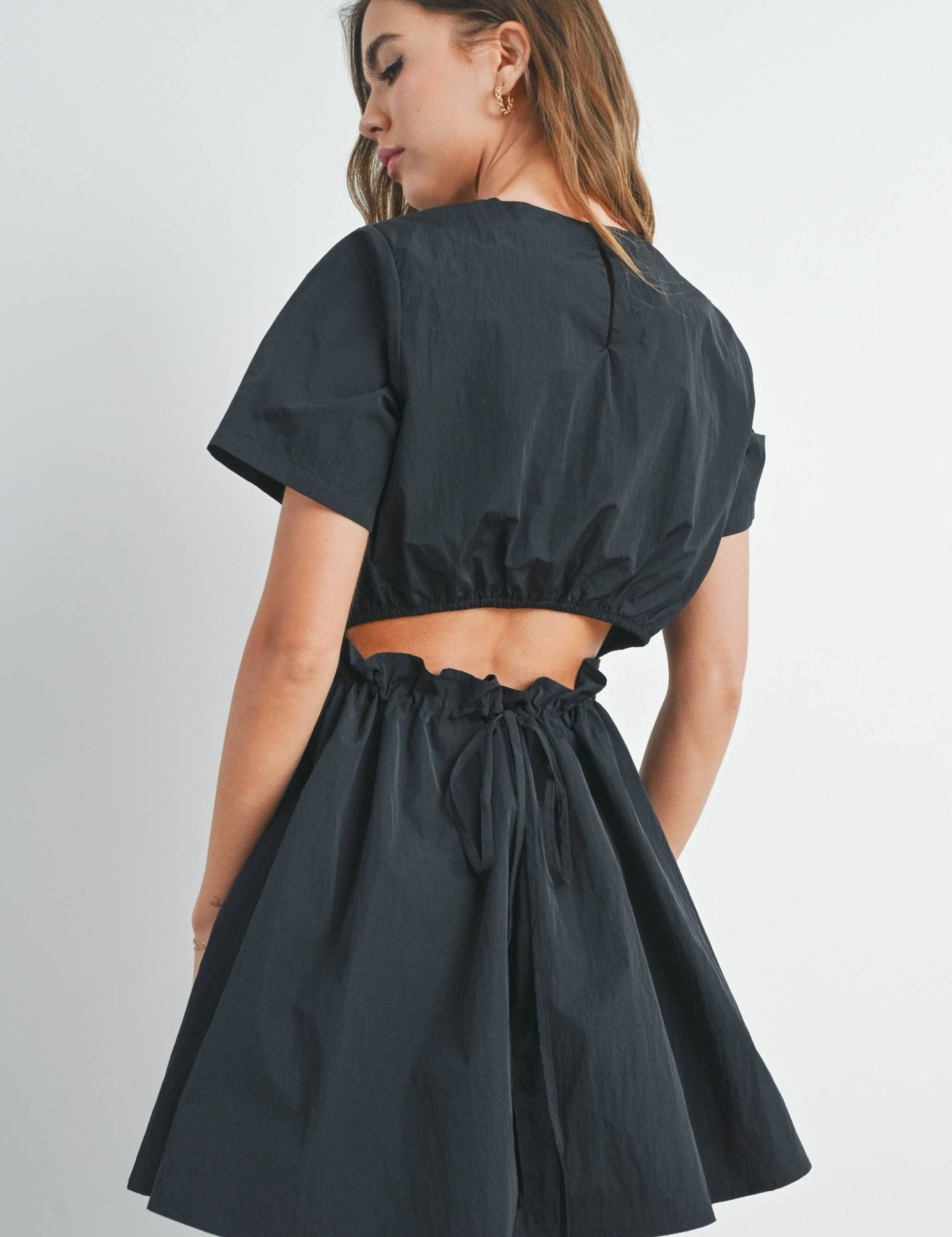 Luella Tie Back Mini DressThe Tie Back Mini Dress is a chic and versatile wardrobe staple that effortlessly combines style and comfort. This fashionable dress features a flattering mini length, showcasing your legs while providing a trendy look. The defin