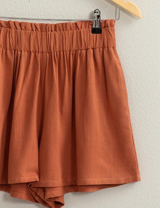 Lynne Paper Bag ShortsIntroducing our Lynne Paper Bag Waist Relaxed Shorts, the epitome of chic and comfort. Elevate your summer wardrobe with these effortlessly stylish shorts, featuring a paper bag elasticated high waist that cinches the fit for a flatt