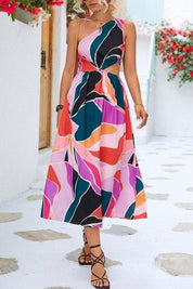 Nora Printed DressStep into summer with the Nora Printed Dress, a stunning one-shoulder design that exudes effortless elegance. Featuring a vibrant print and a small insert at the waist, this dress is perfect for making a statement at any occasion. The on