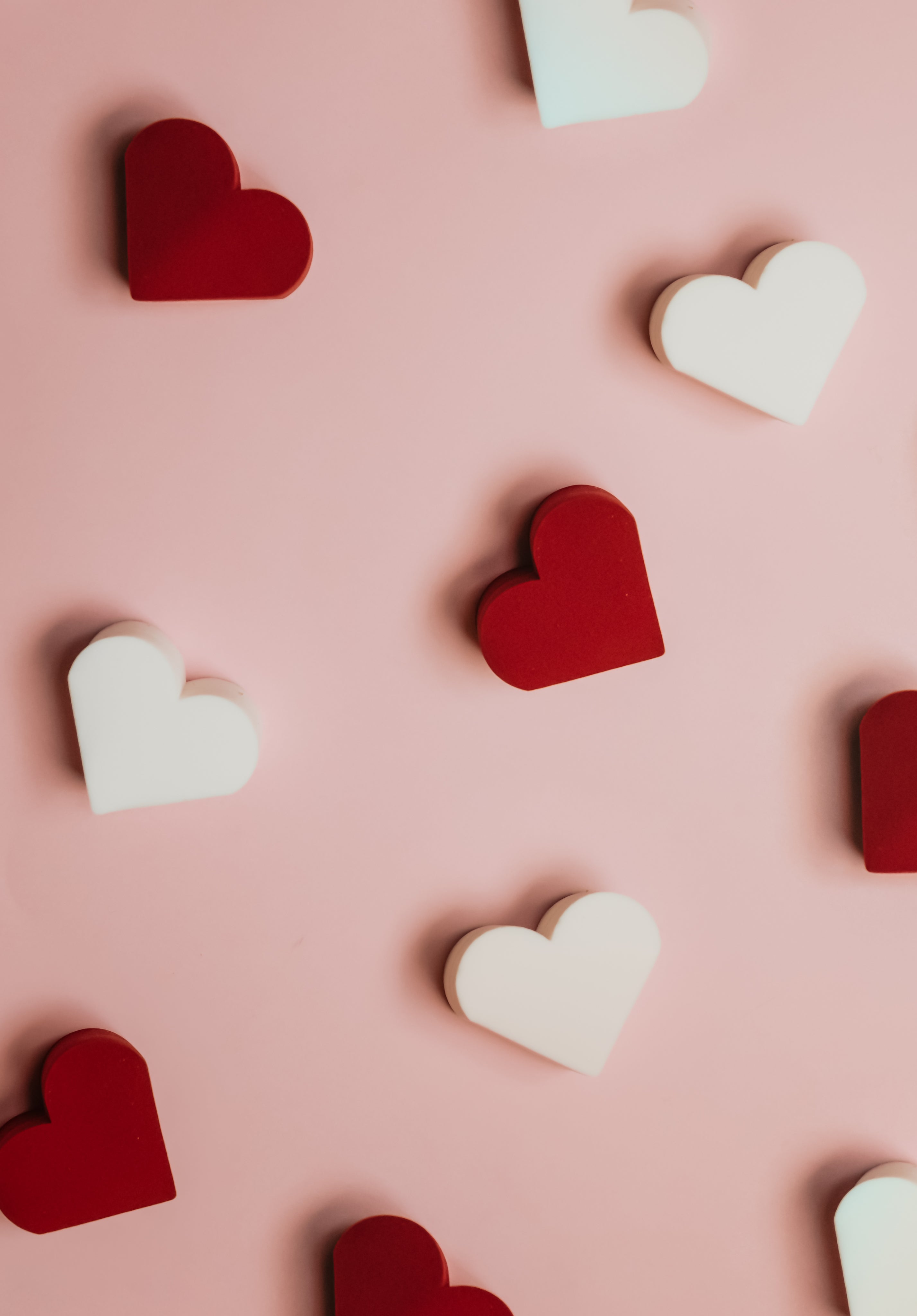 red-and-white-hearts-scattered-on-pink-surface.jpg