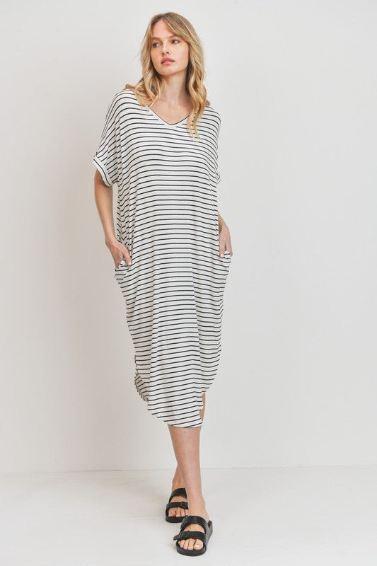 Rina Stripe DressIntroducing our Rounded Hems Striped Rib Knit Dress, effortlessly blending comfort with style. Crafted from a heavyweight, stretchy rib knit fabric, this dress features a relaxed silhouette with rounded hems and convenient pockets. With a