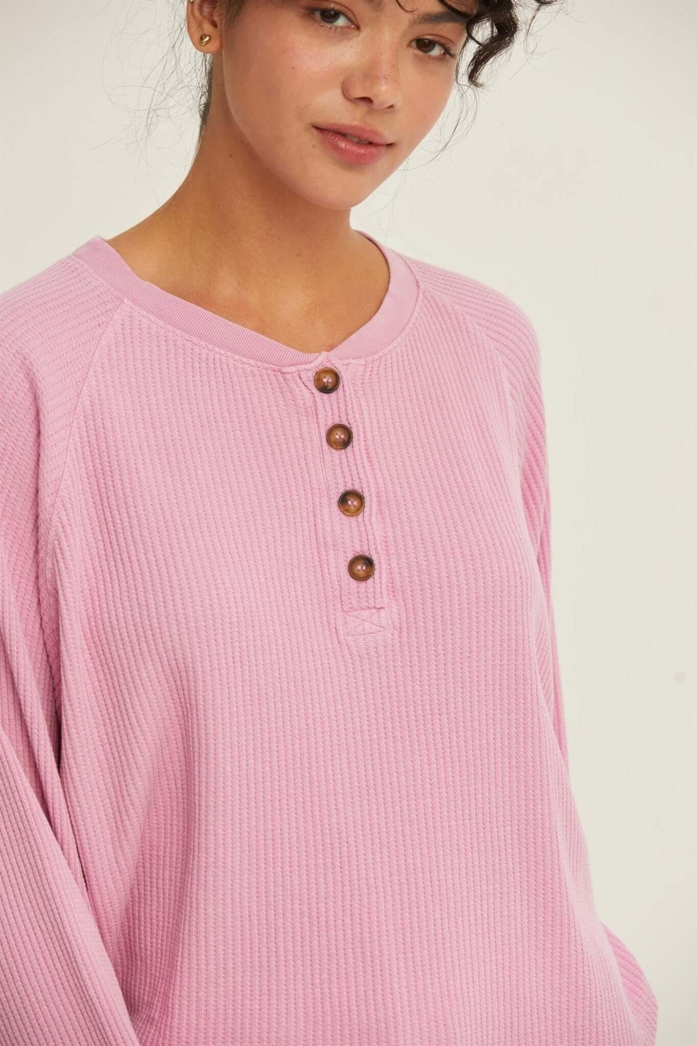 Rose Raglan TopThe Rose Raglan Crew combines comfort and style with its relaxed silhouette. Featuring a classic Henley design with a button placket, this long sleeve top is crafted from soft, textured waffle knit fabric that adds a cozy feel. The raglan s