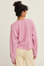 Rose Raglan TopThe Rose Raglan Crew combines comfort and style with its relaxed silhouette. Featuring a classic Henley design with a button placket, this long sleeve top is crafted from soft, textured waffle knit fabric that adds a cozy feel. The raglan s