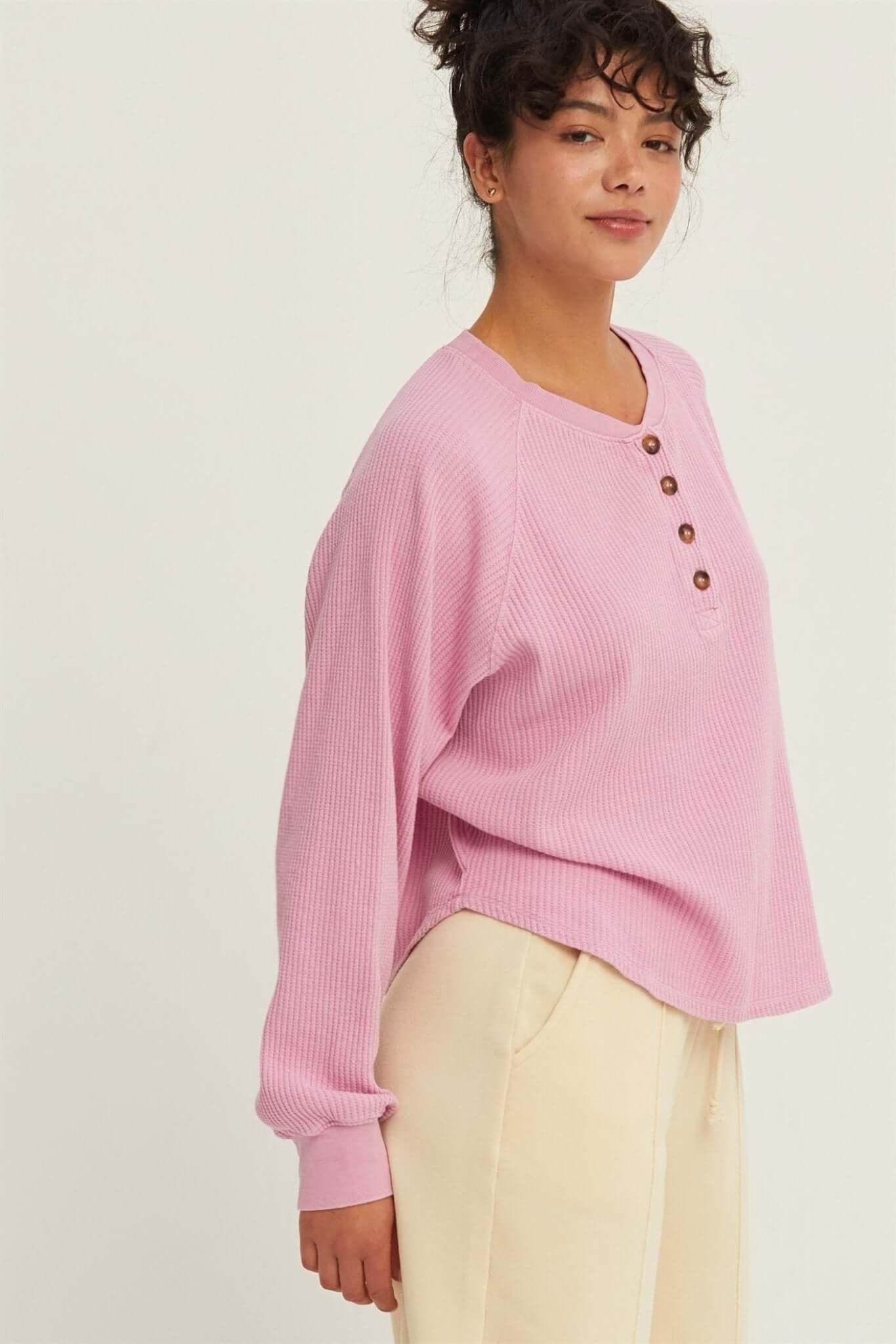 Rose Raglan TopThe Rose Raglan Crew combines comfort and style with its relaxed silhouette. Featuring a classic Henley design with a button placket, this long sleeve top is crafted from soft, textured waffle knit fabric that adds a cozy feel. The raglan s