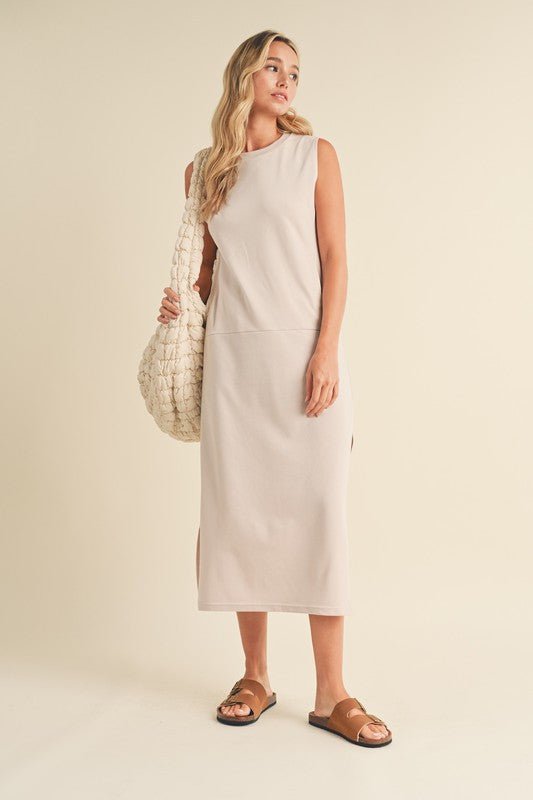 Rosie Midi DressIntroducing our Sleeveless Terry Cloth Midi Dress – a blend of comfort and style for your summer wardrobe.Crafted from soft terry cloth fabric, this midi-length dress keeps you cool and cozy all day. The sleeveless design is perfect for su