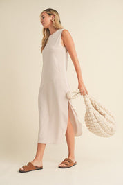 Rosie Midi DressIntroducing our Sleeveless Terry Cloth Midi Dress – a blend of comfort and style for your summer wardrobe.Crafted from soft terry cloth fabric, this midi-length dress keeps you cool and cozy all day. The sleeveless design is perfect for su