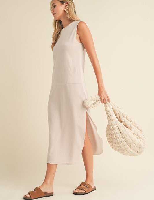 Rosie Midi DressIntroducing our Sleeveless Terry Cloth Midi Dress – a blend of comfort and style for your summer wardrobe.Crafted from soft terry cloth fabric, this midi-length dress keeps you cool and cozy all day. The sleeveless design is perfect for su
