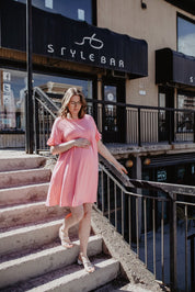 Lisa Ruffle Sleeve DressPRODUCT DESCRIPTION: The Lisa Ruffle Dress is an easy to wear piece for the spring & summer that grows with you and can easily be worn post partum. Features a babydoll silhouette, a round neckline, short ruffle sleeves, and side po