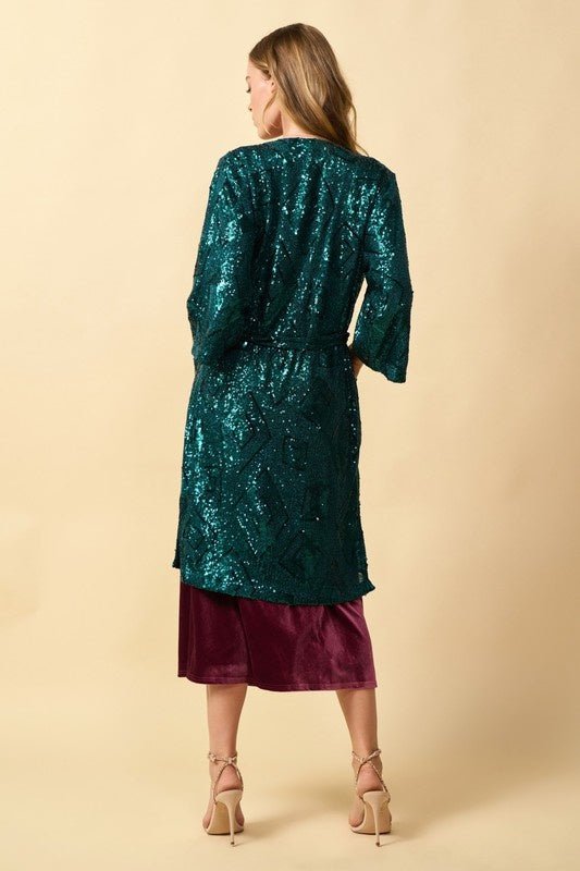 Madeline Sequin Kimono - FINAL SALEDESCRIPTION: Sequined midi length kimono with waist tie, 3/4 bell sleeves, and front pockets. Made In: Imported Content: body 95% Polyester / 5% Spandex lining 100% Polyester Washing Instructions: Dry Clean Only Fit: TTS