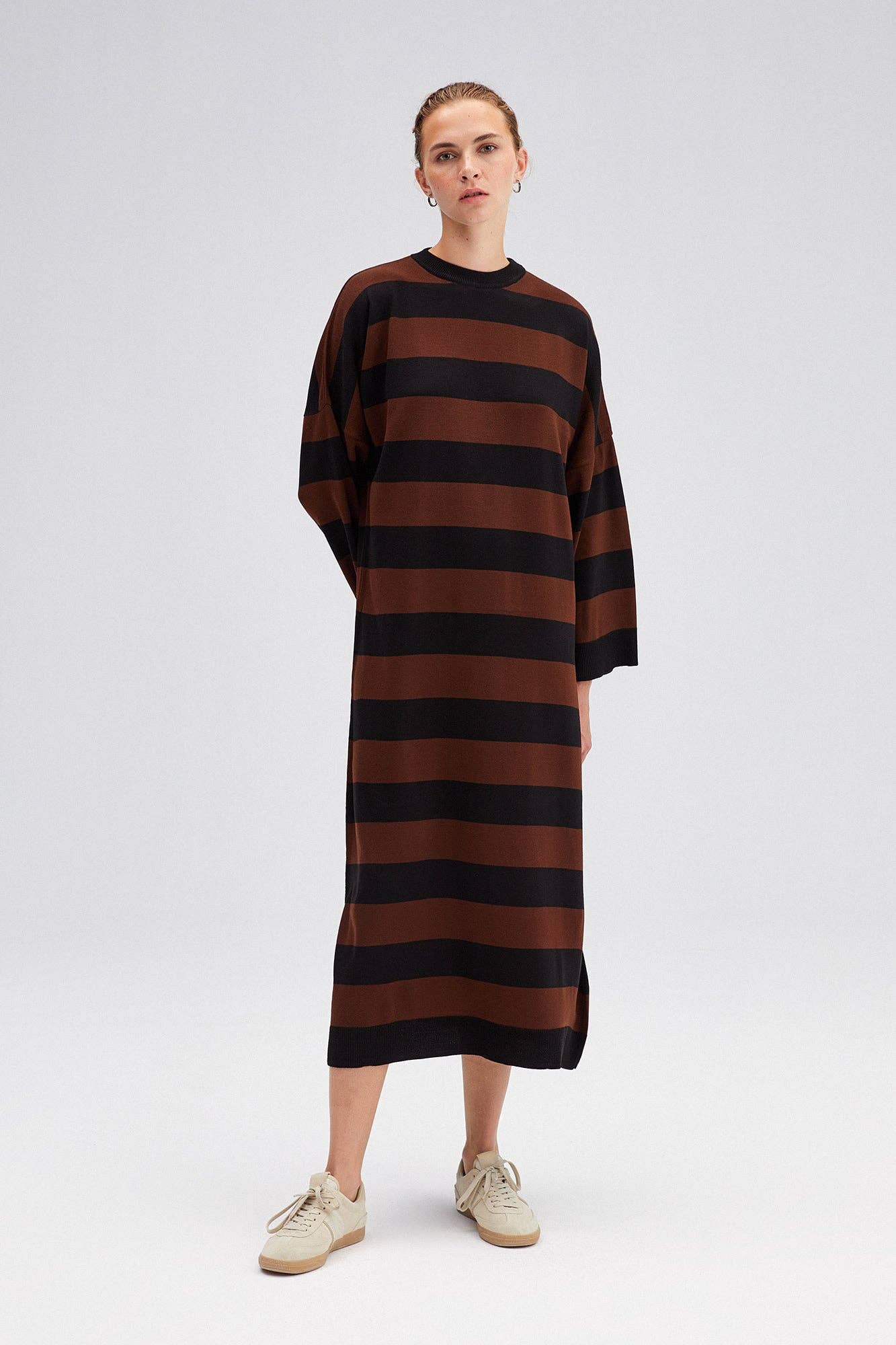 Orly Striped Knit Dress - FINAL SALEThis striped sweater dress features a fun neutral stripe pattern, round neckline, & bell sleeves, all in a soft & cozy knit. Pair with tall boots and your favourite long coat for a chic look. SIZE & FIT Fit: This garmen