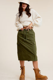 Ulla Cargo Pocket SkirtCombine the details of your favorite cargo pants with the sophisticated silhouette of a midi skirt with this stunning piece. It features a mid-rise, elasticated waistband with drawstring, and a slit at the back for added comfort and