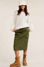 Ulla Cargo Pocket SkirtCombine the details of your favorite cargo pants with the sophisticated silhouette of a midi skirt with this stunning piece. It features a mid-rise, elasticated waistband with drawstring, and a slit at the back for added comfort and