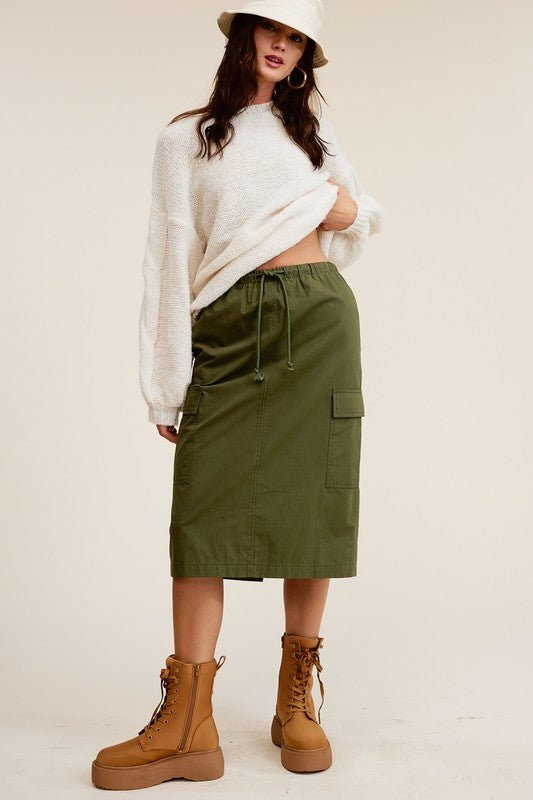 Ulla Cargo Pocket SkirtCombine the details of your favorite cargo pants with the sophisticated silhouette of a midi skirt with this stunning piece. It features a mid-rise, elasticated waistband with drawstring, and a slit at the back for added comfort and